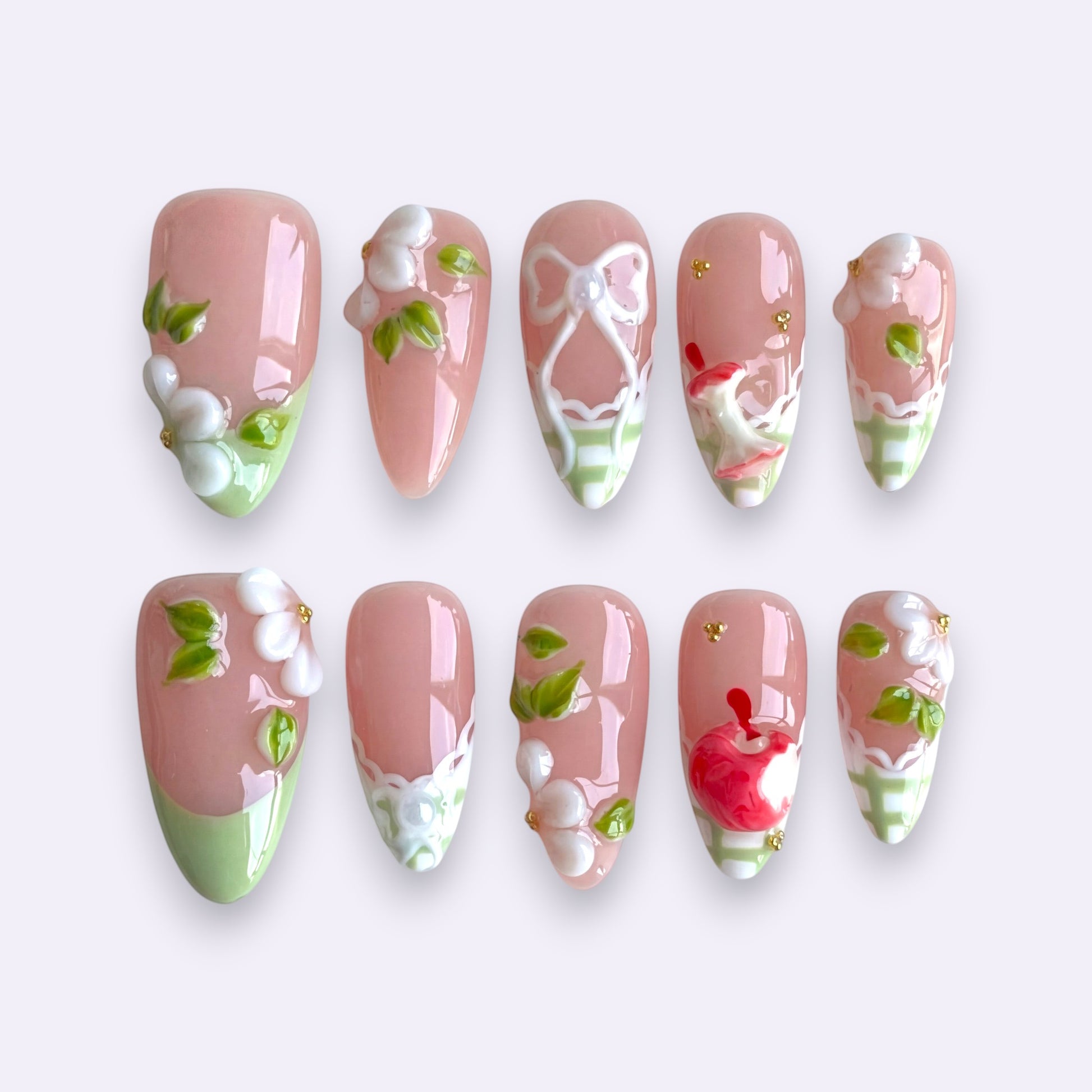 PearlFizzy Orchard Picnic handmade press-on nails with mint green French tips, 3D apples, flowers, and bows.